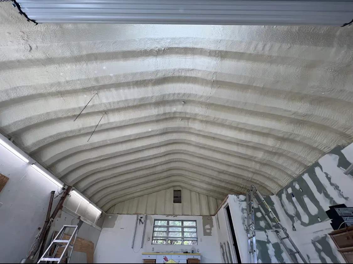 Spray polyurethane foam applied to the underside of a metal roof deck in Medfield